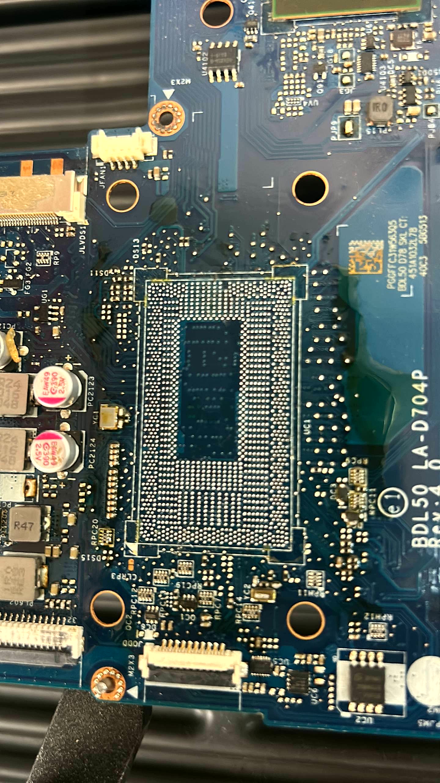 Laptop motherboard showing the on-board BGA CPU before vSource chip-level removal
