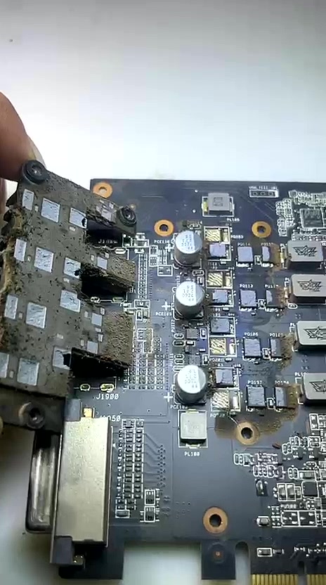 Graphics card before repair at vSource Pune — heavy corrosion and burnt residue on GPU VRM section