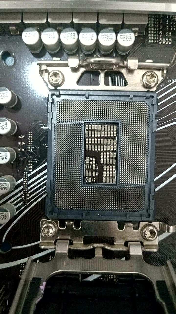LGA CPU socket with bent pins before vSource restoration · multiple pins damaged